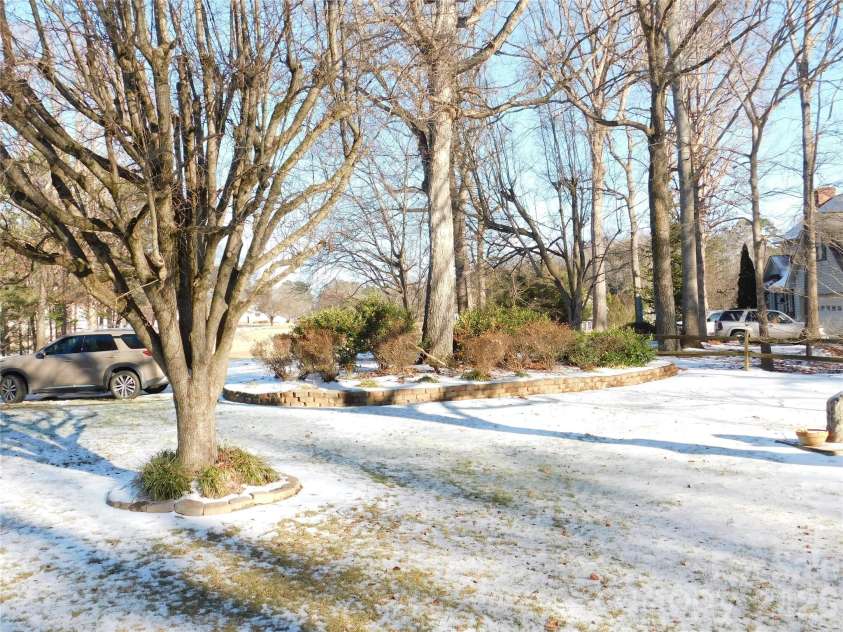 175 Briarfield Drive, Mooresville, NC 28115.  MLS# CAR4342091, YatesRealty ID 3356. View of the fence on right side and flower beds (I will have better photos once snow has melted)