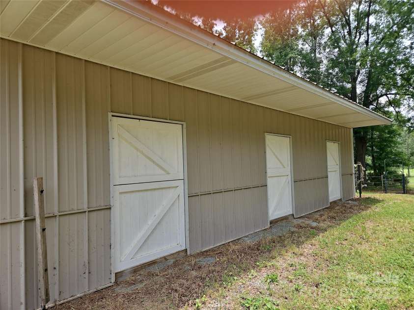 2905 Medlin Road, Monroe, NC 28112.  MLS# CAR4267802, YatesRealty ID 3356. Outside doors on both sides of barn