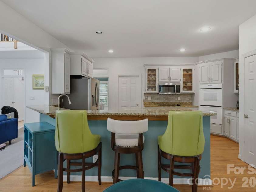 21311 Crown Lake Drive, Cornelius, NC 28031.  MLS# CAR4387375, YatesRealty ID 33569. Bar Seating in Kitchen