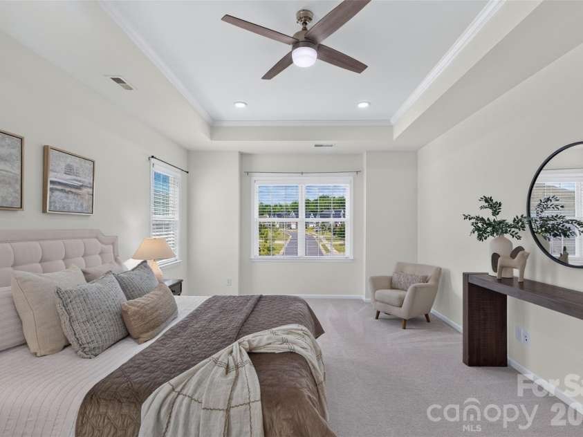 2249 Idol Rock Drive, Fort Mill, SC 29707.  MLS# CAR4396380, YatesRealty ID 33582. Luxurious primary bedroom with tray ceiling