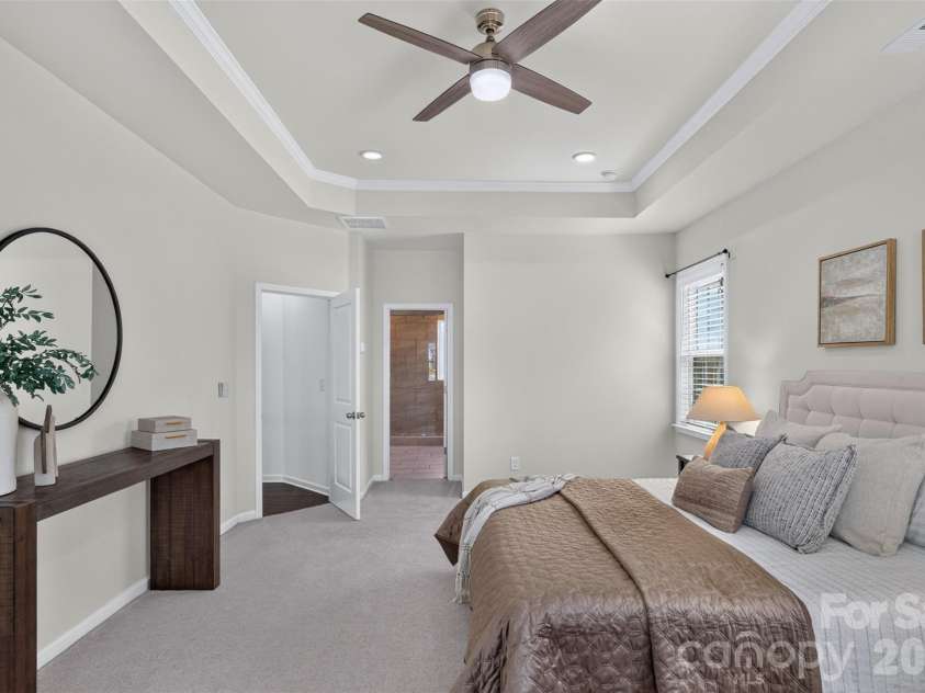 2249 Idol Rock Drive, Fort Mill, SC 29707.  MLS# CAR4396380, YatesRealty ID 33582. Luxurious primary bedroom with tray ceiling