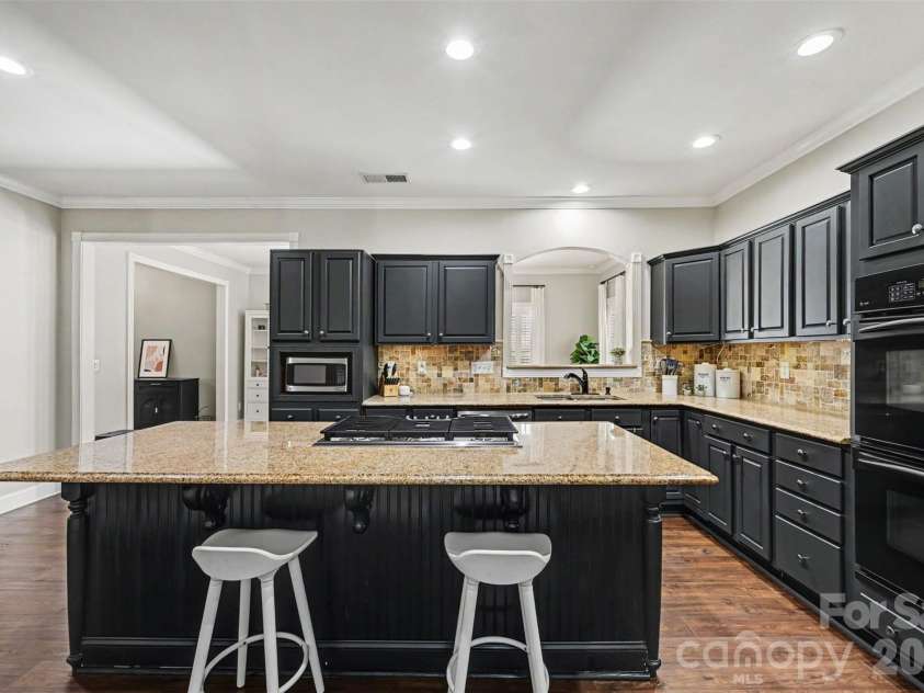 2442 Smith Cove Road, Denver, NC 28037.  MLS# CAR4396728, YatesRealty ID 33588. Large kitchen with see through pass way into another dining area or flex space. Double ovens and gas cook top ready for the chef!