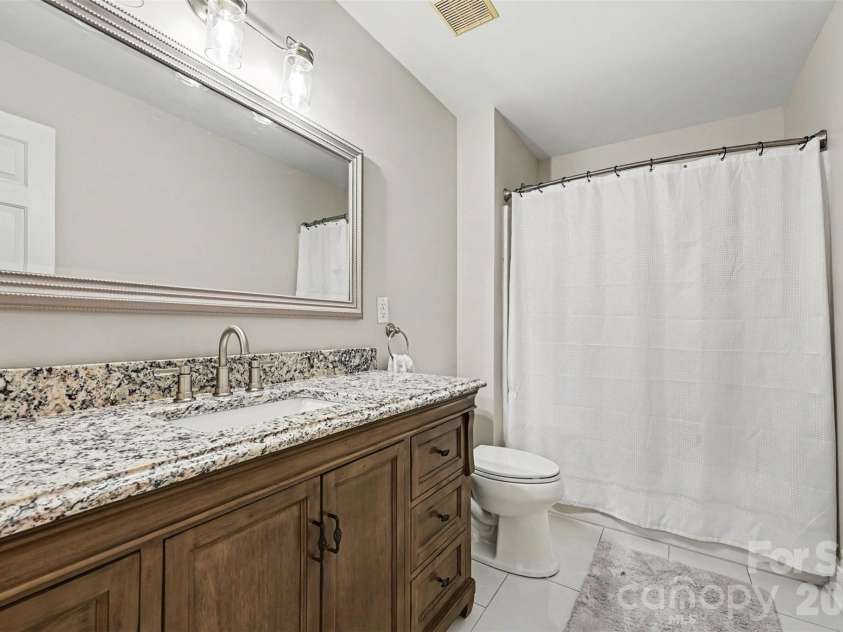 2442 Smith Cove Road, Denver, NC 28037.  MLS# CAR4396728, YatesRealty ID 33588. Upper full bath with new tile flooring.