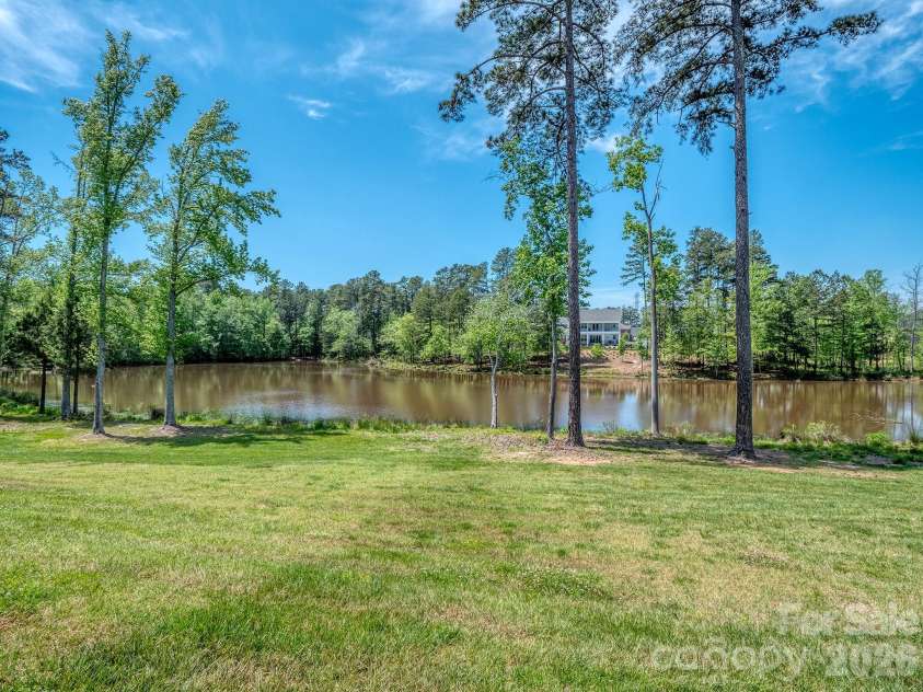 121 Enclave Boulevard, Weddington, NC 28104.  MLS# CAR4395615, YatesRealty ID 33597. Community greenspace with pond