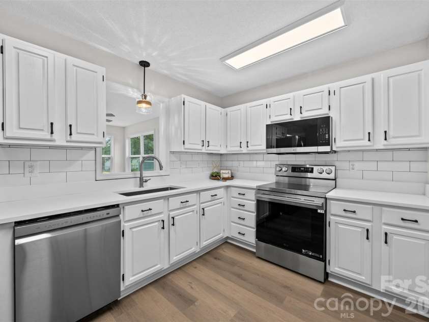 322 57th Street, Oak Island, NC 28465.  MLS# CAR4354711, YatesRealty ID 33606. Kitchen featuring a pass through window into the Sunroom while entertaining guests.