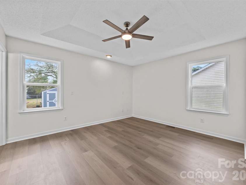 322 57th Street, Oak Island, NC 28465.  MLS# CAR4354711, YatesRealty ID 33606. Primary Bedroom featuring a tray ceiling.