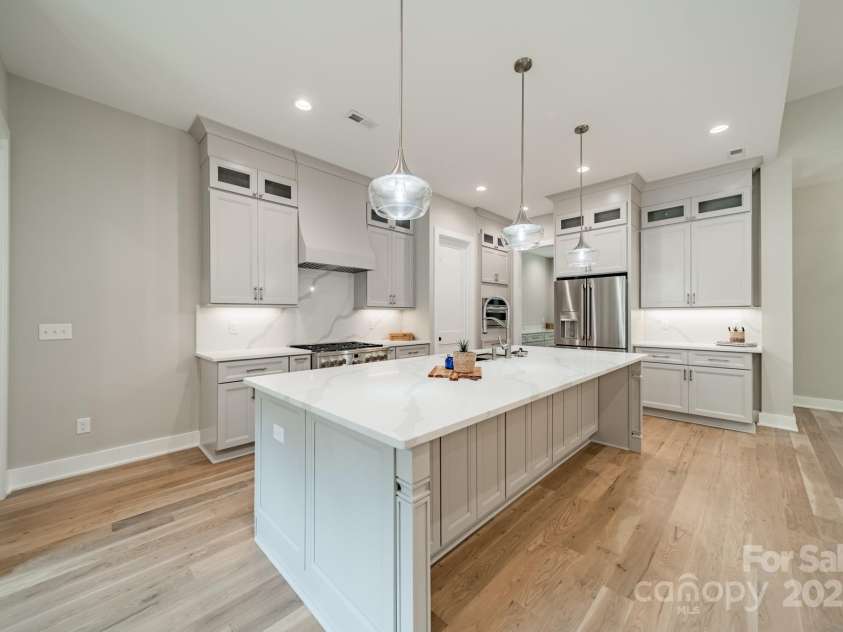 4028 Spindrift Cove Drive, Denver, NC 28037.  MLS# CAR4270075, YatesRealty ID 33617. Fabulous Chef's Kitchen with oversized Gas Range and Oven, Quartz Counter Tops and Backsplash, and Custom Cabinetry