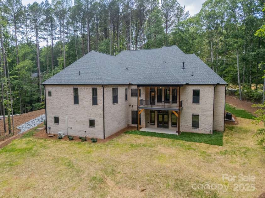 4028 Spindrift Cove Drive, Denver, NC 28037.  MLS# CAR4270075, YatesRealty ID 33617. Gorgeous brick surrounds the sides and back of the home adding luxury to this beautiful, private, lakefront Estate