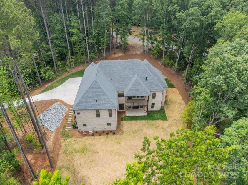 4028 Spindrift Cove Drive, Denver, NC 28037.  MLS# CAR4270075, YatesRealty ID 33617. Gorgeous brick surrounds the sides and back of the home adding luxury to this beautiful, private, lakefront Estate