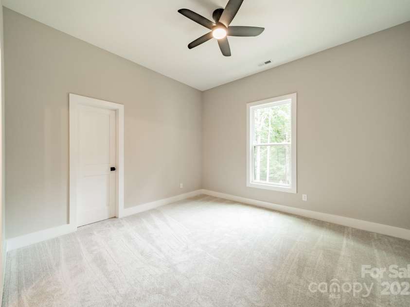 4028 Spindrift Cove Drive, Denver, NC 28037.  MLS# CAR4270075, YatesRealty ID 33617. Spacious Bedroom 2 on the Main Level with a Walk-in Closet overlooking Lake Norman