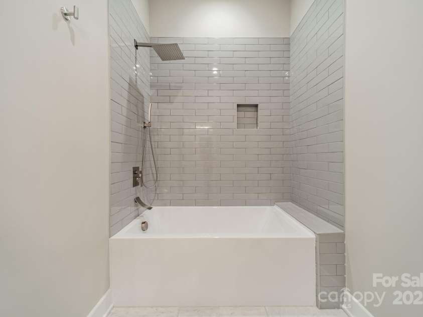 4028 Spindrift Cove Drive, Denver, NC 28037.  MLS# CAR4270075, YatesRealty ID 33617. Stunning Full Bathroom for Main Level Bedrooms 1 and 2 with beautiful tilework