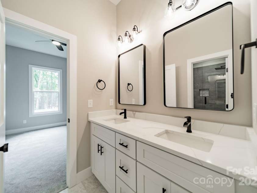 4028 Spindrift Cove Drive, Denver, NC 28037.  MLS# CAR4270075, YatesRealty ID 33617. The Lower Level Full Bathroom serves Bedroom 3 and 4 with stunning Quartz Countertops