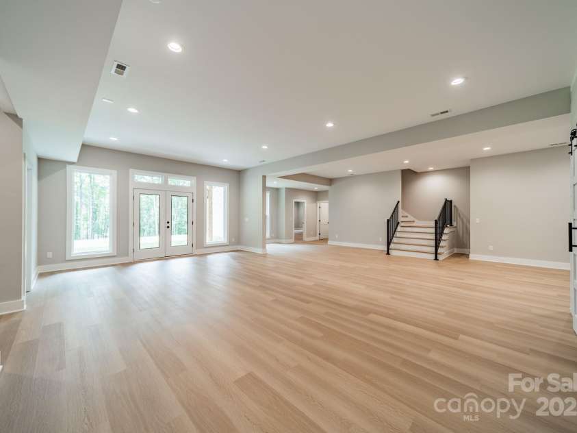 4028 Spindrift Cove Drive, Denver, NC 28037.  MLS# CAR4270075, YatesRealty ID 33617. The Lower Level Living room is expansive and leads you to Lake Norman