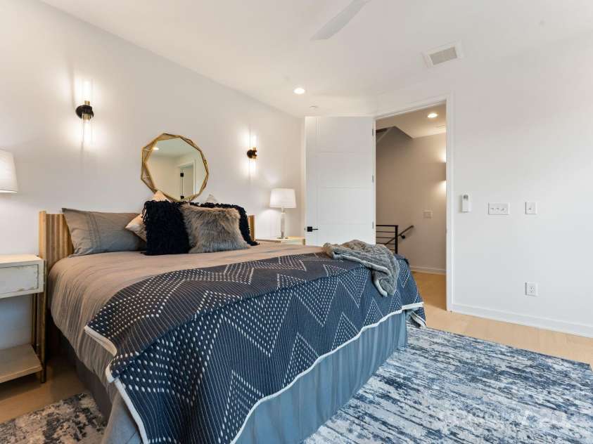 412 State Street, Charlotte, NC 28208.  MLS# CAR4273285, YatesRealty ID 33628. Primary bedroom with sconce lighting.