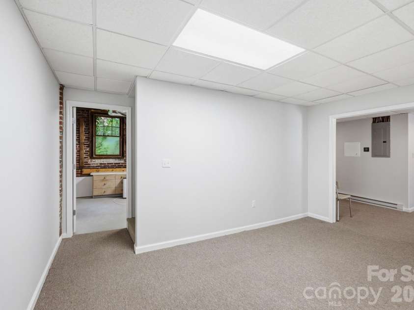23 Warwick Place, Asheville, NC 28804.  MLS# CAR4394325, YatesRealty ID 33637. Basement space for whatever.