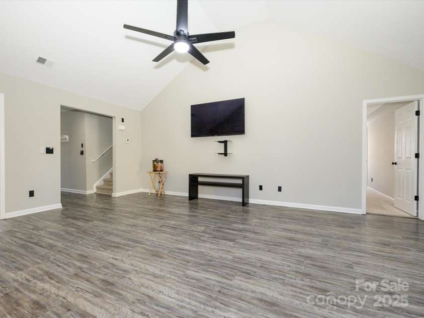 7220 Hidden Creek Drive, Charlotte, NC 28214.  MLS# CAR4225936, YatesRealty ID 3364. Great room with ceiling fan, wall-mounted tv and bracket to convey