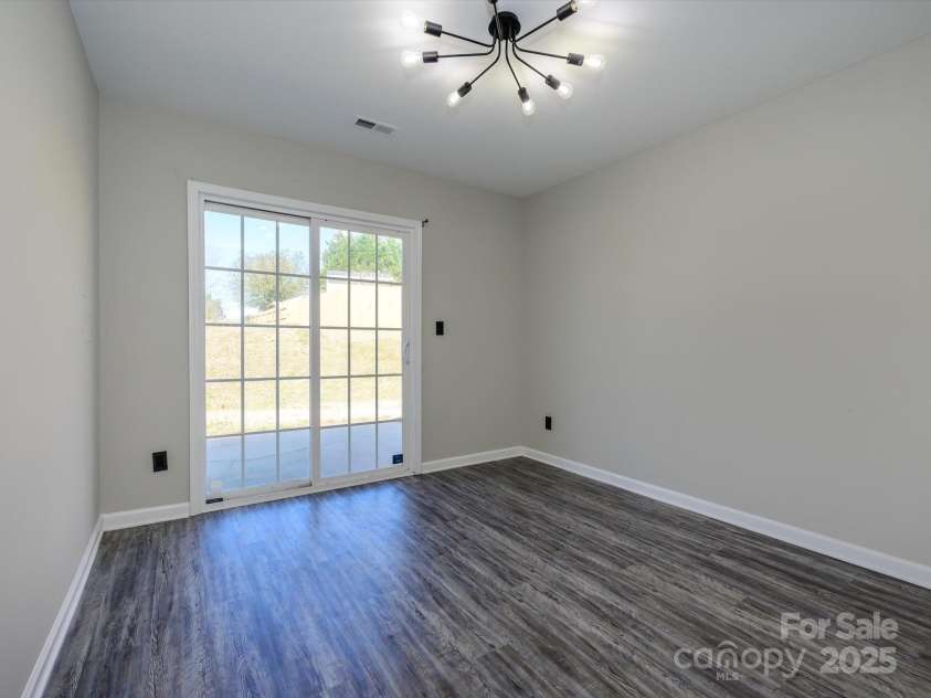 7220 Hidden Creek Drive, Charlotte, NC 28214.  MLS# CAR4225936, YatesRealty ID 3364. Sunroom/flex space with vinyl plank flooring
