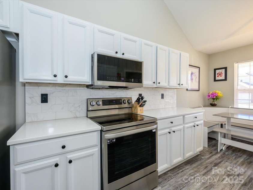 7220 Hidden Creek Drive, Charlotte, NC 28214.  MLS# CAR4225936, YatesRealty ID 3364. Upgraded white kitchen with vinyl flooring