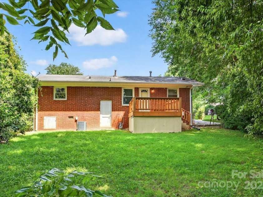 2221 Ludlow Drive, Charlotte, NC 28216.  MLS# CAR4292812, YatesRealty ID 33644. Exterior back view of the home featuring a storage closet. Additional storage space is located under the deck.