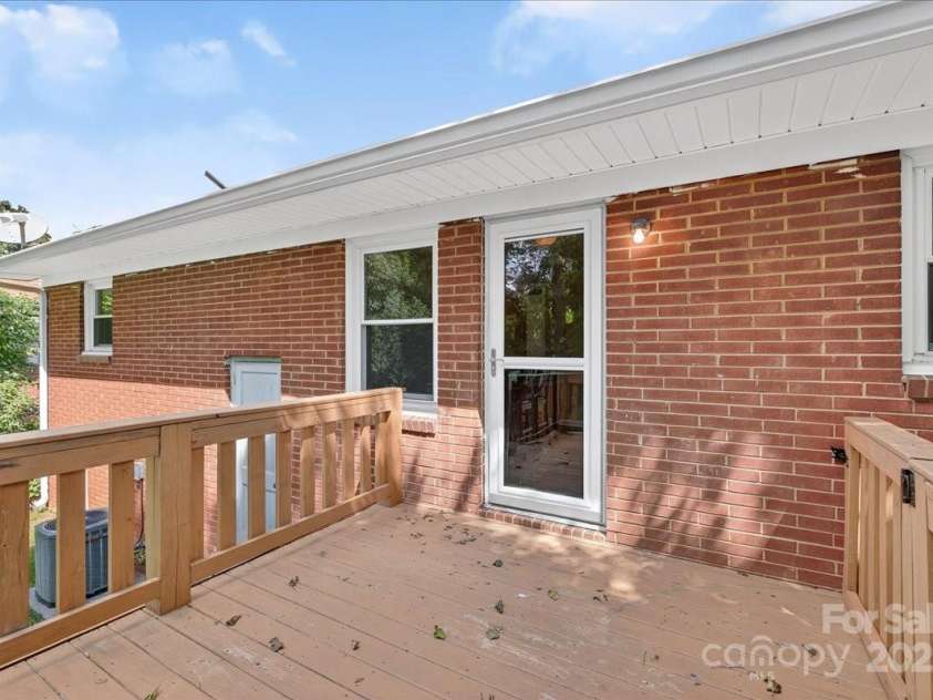 2221 Ludlow Drive, Charlotte, NC 28216.  MLS# CAR4292812, YatesRealty ID 33644. Large deck off the dining room with stair access to the backyard!