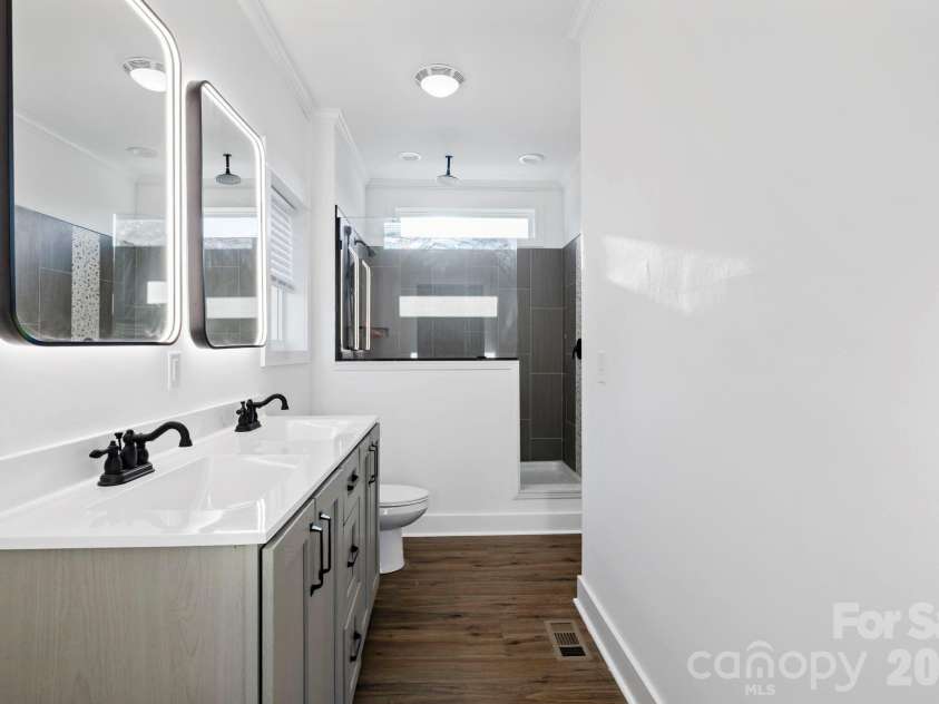 203 Southern Charm Road, Arden, NC 28704.  MLS# CAR4342838, YatesRealty ID 3365. Dual sink w/ LED Lighted Vanity mirrors and large shower w/ window