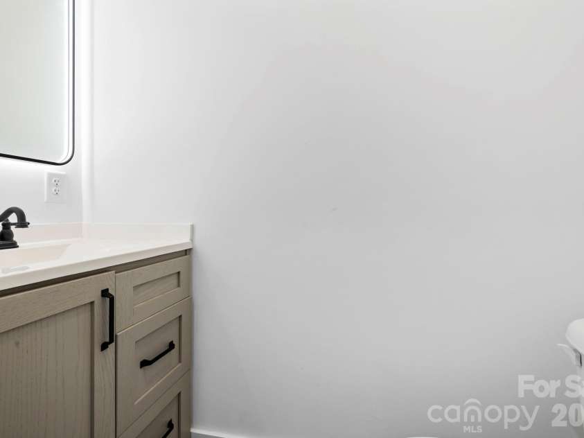 203 Southern Charm Road, Arden, NC 28704.  MLS# CAR4342838, YatesRealty ID 3365. Powder Bath w/ storage vanity & LED Lighted mirror
