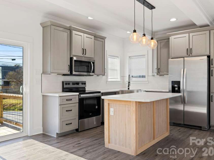 203 Southern Charm Road, Arden, NC 28704.  MLS# CAR4342838, YatesRealty ID 3365. Two tone cabinetry w/ Pantry beside fridge 