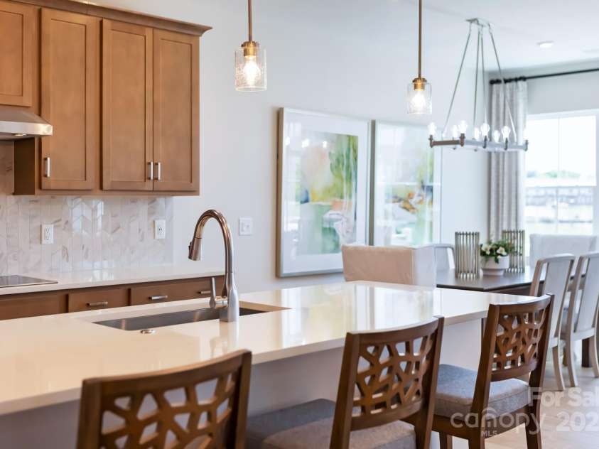 8928 Connover Hall Avenue, Charlotte, NC 28215.  MLS# CAR4199321, YatesRealty ID 3365. PLAN 3 MODEL KITCHEN AND DINING | This is a model of the home design. Please note that this is a representation only and the final construction may differ in appearance, features, and finishes