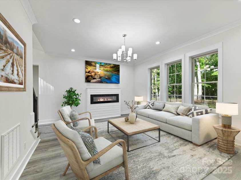 1409 Bloomsberry Lane, Waxhaw, NC 28173.  MLS# CAR4247521, YatesRealty ID 33651. Great room with fireplace overlooking the private backyard- virtually staged
