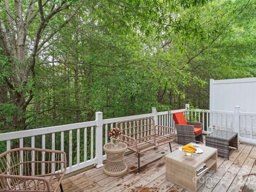 864 Tiger Lane, Charlotte, NC 28262.  MLS# CAR4278320, YatesRealty ID 33655. Enjoy your morning coffee or unwind in the evenings on this private, tree-lined deck with plenty of room for seating and relaxation.