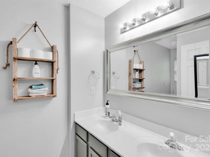 864 Tiger Lane, Charlotte, NC 28262.  MLS# CAR4278320, YatesRealty ID 33655. Primary bath with dual vanity and tub/shower combo