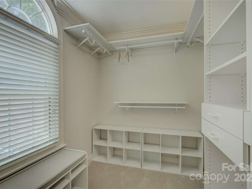 15608 Woodland Ridge Lane, Charlotte, NC 28278.  MLS# CAR4283839, YatesRealty ID 33663. Primary closet with built-in shelving. Two separate closets included at primary bathroom