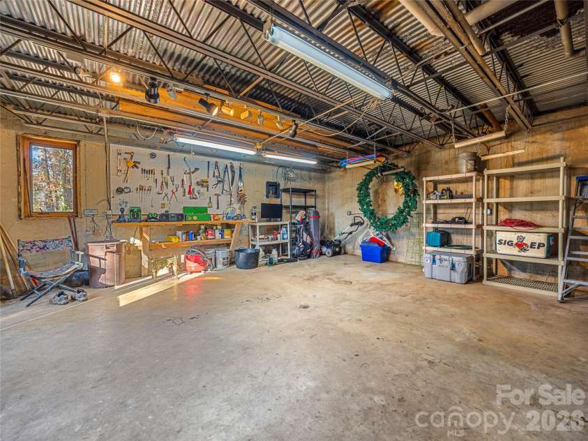 339 Beaverdam Road, Asheville, NC 28804.  MLS# CAR4321982, YatesRealty ID 3367. A dream workspace for creatives, hobbyists, or DIY enthusiasts—this oversized workshop features ample storage, deep workbenches, and room to spread out and bring big projects to life.