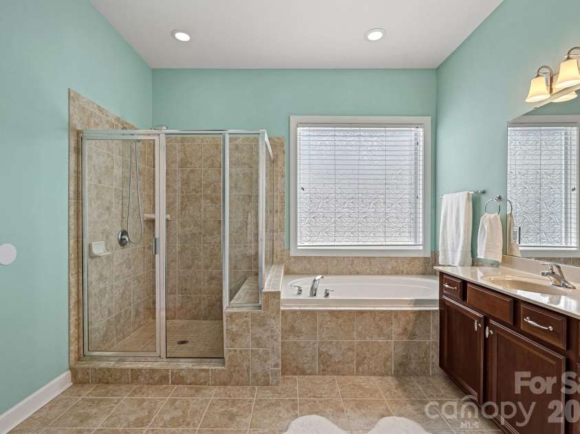 10654 Rippling Stream Drive, Concord, NC 28027.  MLS# CAR4387209, YatesRealty ID 33670. Primary bath with soaking tub and separate shower