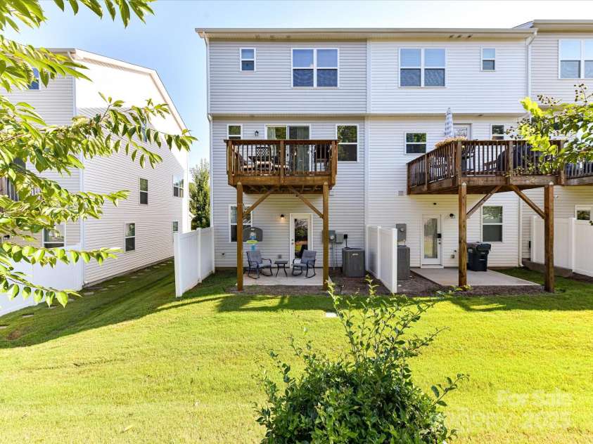 2313 Lazette Drive, Charlotte, NC 28216.  MLS# CAR4291354, YatesRealty ID 33693. Exterior Back of end unit townhome with covered, main level patio & upper level deck!