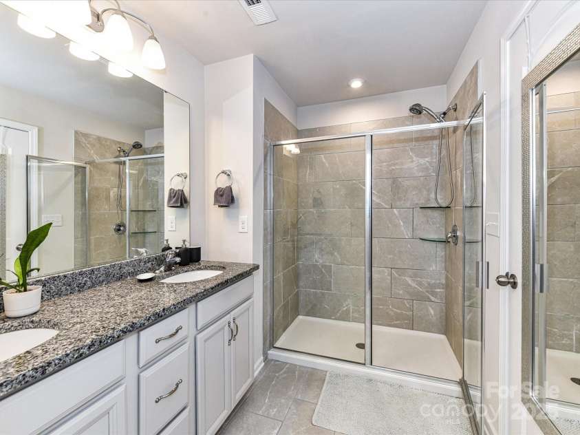 2313 Lazette Drive, Charlotte, NC 28216.  MLS# CAR4291354, YatesRealty ID 33693. Primary Bath features dual, granite vanity, tiled shower & tile floors!