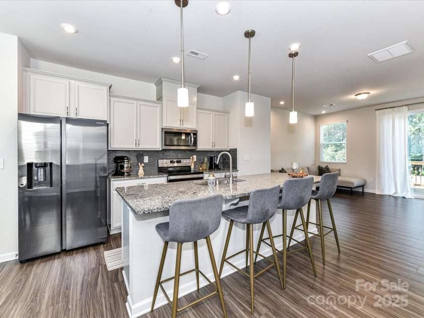 2313 Lazette Drive, Charlotte, NC 28216.  MLS# CAR4291354, YatesRealty ID 33693. Upgraded Kitchen features granite counters, stainless steel appliances with Refrigerator to remain, tile back splash, spacious island with seating/storage, pantry & dining area!