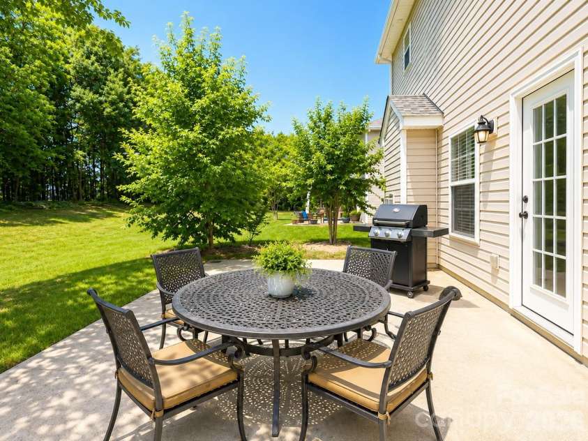 4857 Annelise Drive, Harrisburg, NC 28075.  MLS# CAR4392281, YatesRealty ID 33697. Back patio Virtual staging