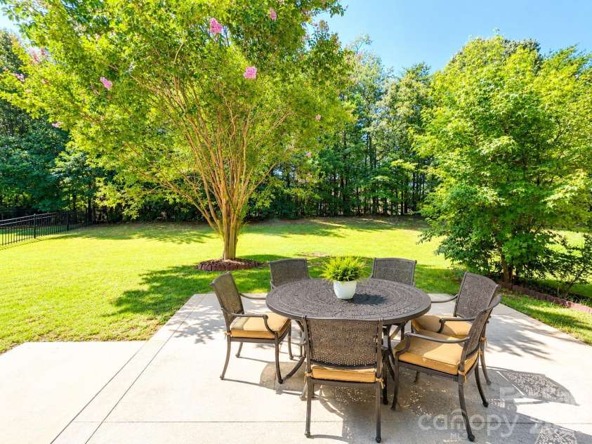 4857 Annelise Drive, Harrisburg, NC 28075.  MLS# CAR4392281, YatesRealty ID 33697. Back yard Virtual staging