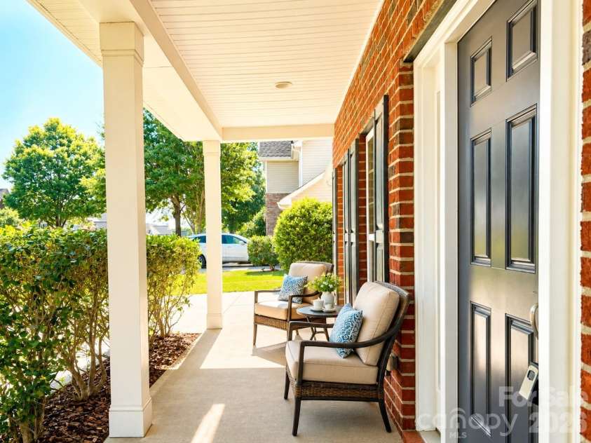 4857 Annelise Drive, Harrisburg, NC 28075.  MLS# CAR4392281, YatesRealty ID 33697. Front covered porch Virtual staging