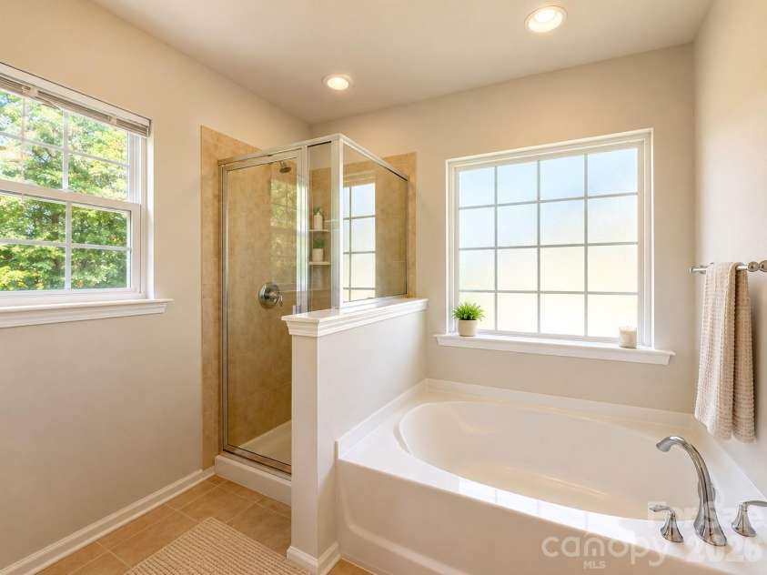 4857 Annelise Drive, Harrisburg, NC 28075.  MLS# CAR4392281, YatesRealty ID 33697. Master tub and tiled shower with two windows