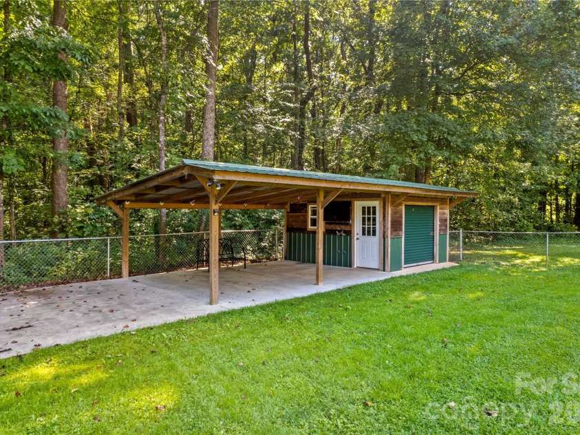 215 Meadow Lake Drive, Salisbury, NC 28146.  MLS# CAR4291335, YatesRealty ID 33699. Large shed with concrete pad and roof.
