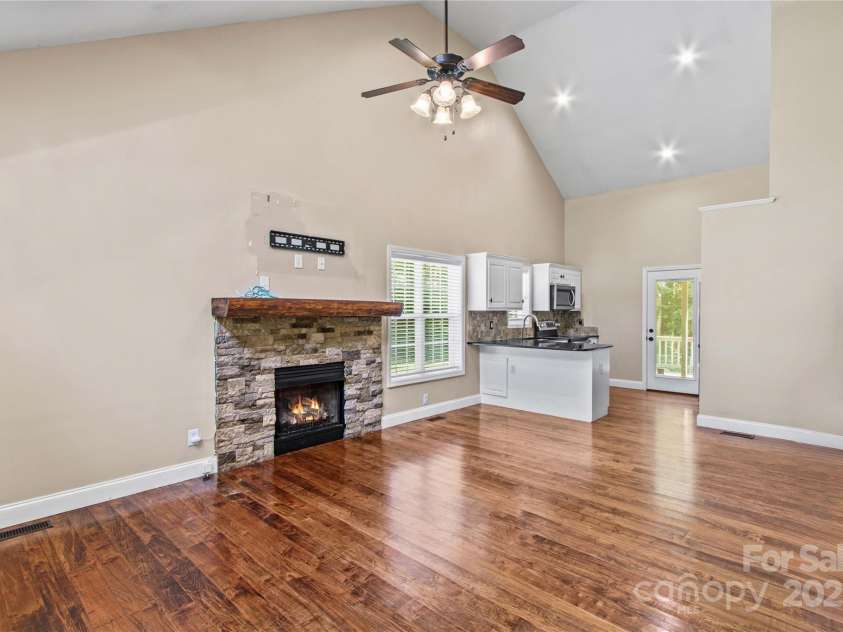 215 Meadow Lake Drive, Salisbury, NC 28146.  MLS# CAR4291335, YatesRealty ID 33699. Living room with locally sourced wood mantle