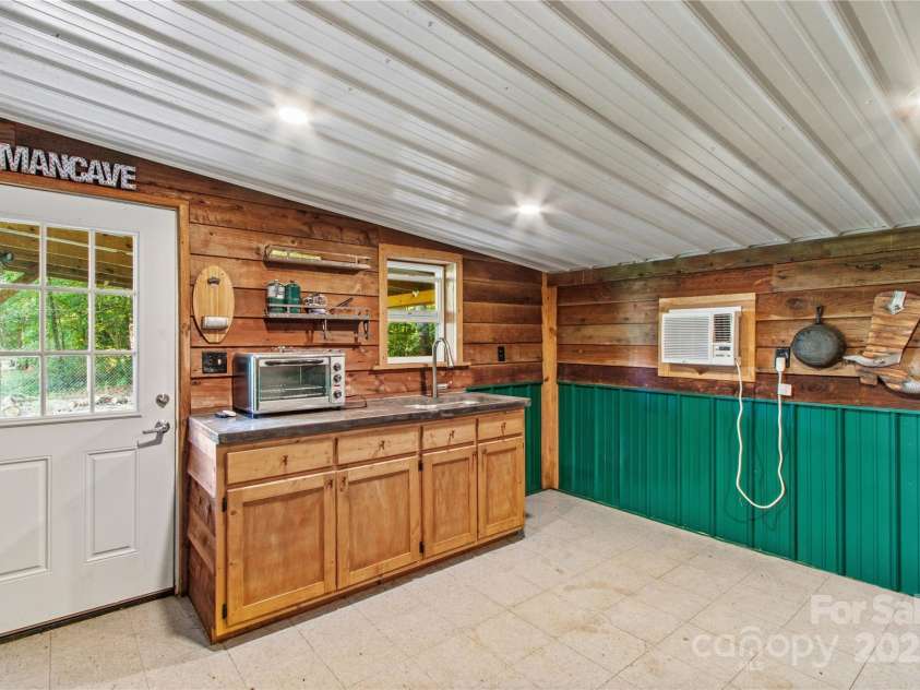 215 Meadow Lake Drive, Salisbury, NC 28146.  MLS# CAR4291335, YatesRealty ID 33699. Shed has HVAC unit, counter top oven, hot and cold water and electricity