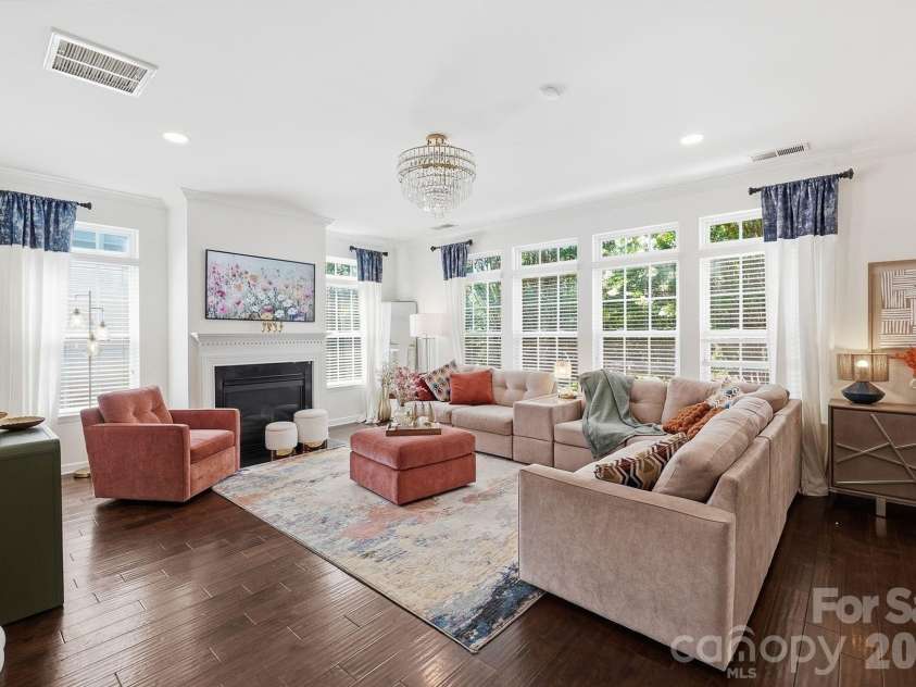 8120 Madrigal Court, Waxhaw, NC 28173.  MLS# CAR4394851, YatesRealty ID 33702. Open floorplan includes great room (pictured here) with windows all around.