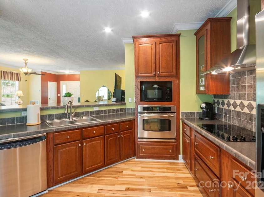 142 Pinners Cove Road, Asheville, NC 28803.  MLS# CAR4287127, YatesRealty ID 33723. Kitchen looking into the living room.