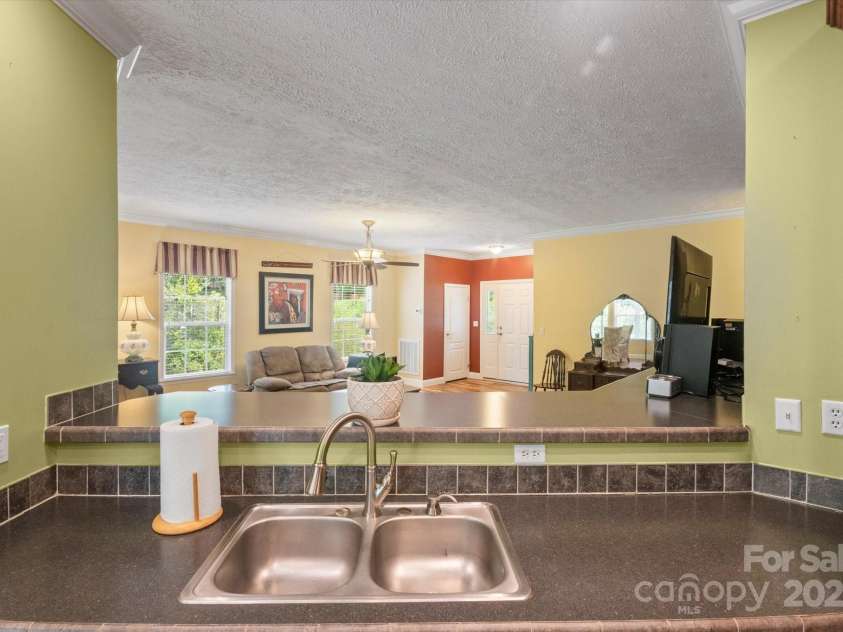 142 Pinners Cove Road, Asheville, NC 28803.  MLS# CAR4287127, YatesRealty ID 33723. Kitchen looking into the living room.