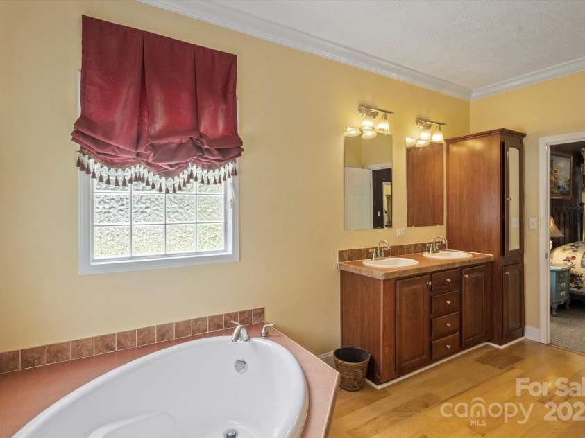 142 Pinners Cove Road, Asheville, NC 28803.  MLS# CAR4287127, YatesRealty ID 33723. Primary bathroom looking into the bedroom.
