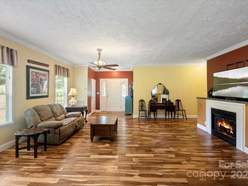 142 Pinners Cove Road, Asheville, NC 28803.  MLS# CAR4287127, YatesRealty ID 33723. The living room looking at the foyer and fireplace.