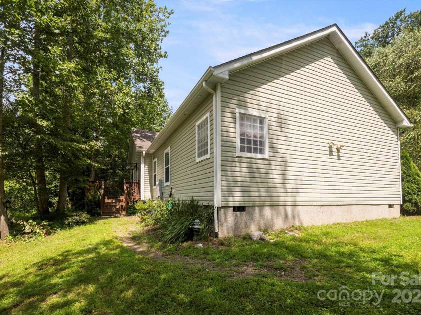142 Pinners Cove Road, Asheville, NC 28803.  MLS# CAR4287127, YatesRealty ID 33723. View of back of home and deck with the creek to the left.